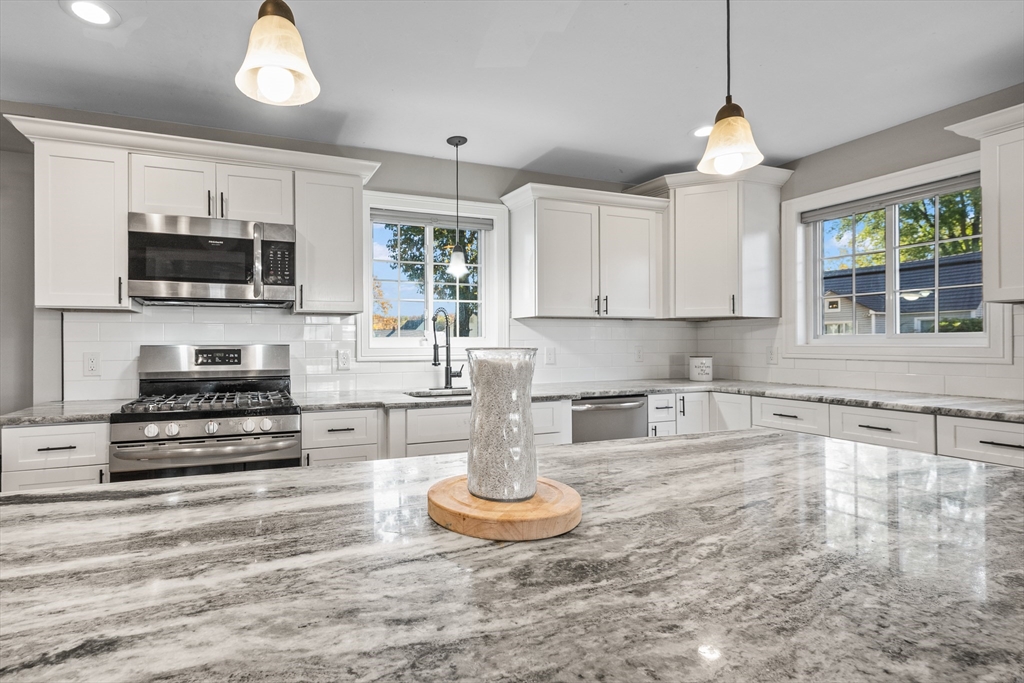 41 Glendale Street Chicopee, MA 01020 - Photo 10 of 42 a kitchen with stainless steel appliances a stove a sink and a microwave
