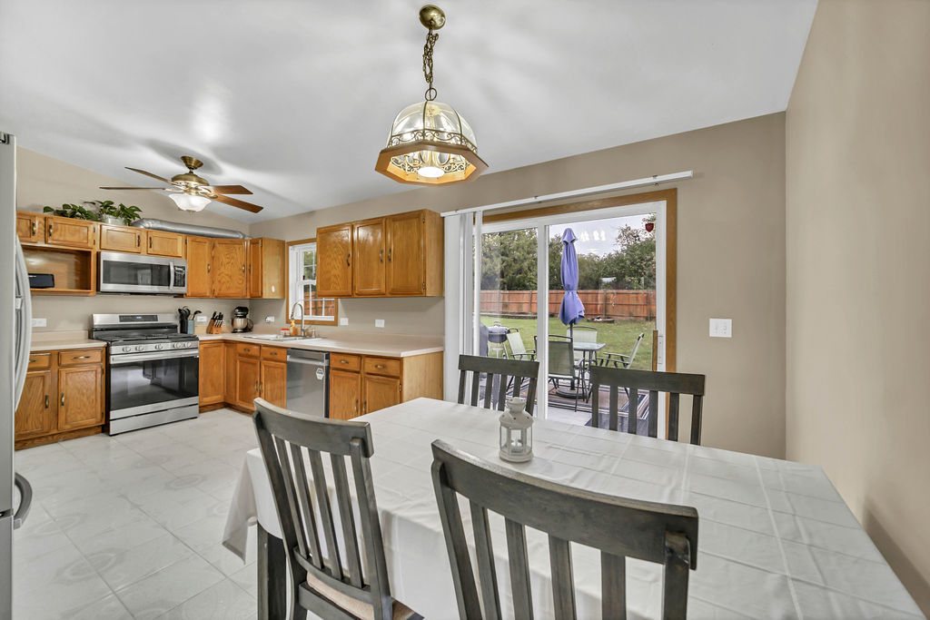 4013 Ridge Road Zion, IL 60099 - Photo 7 of 23 a view of a dining room with furniture chandelier and kitchen view