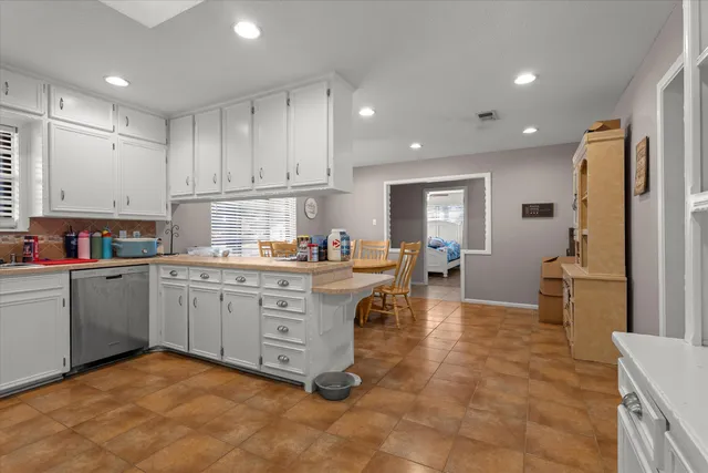 a kitchen that has a lot of cabinets in it and appliances