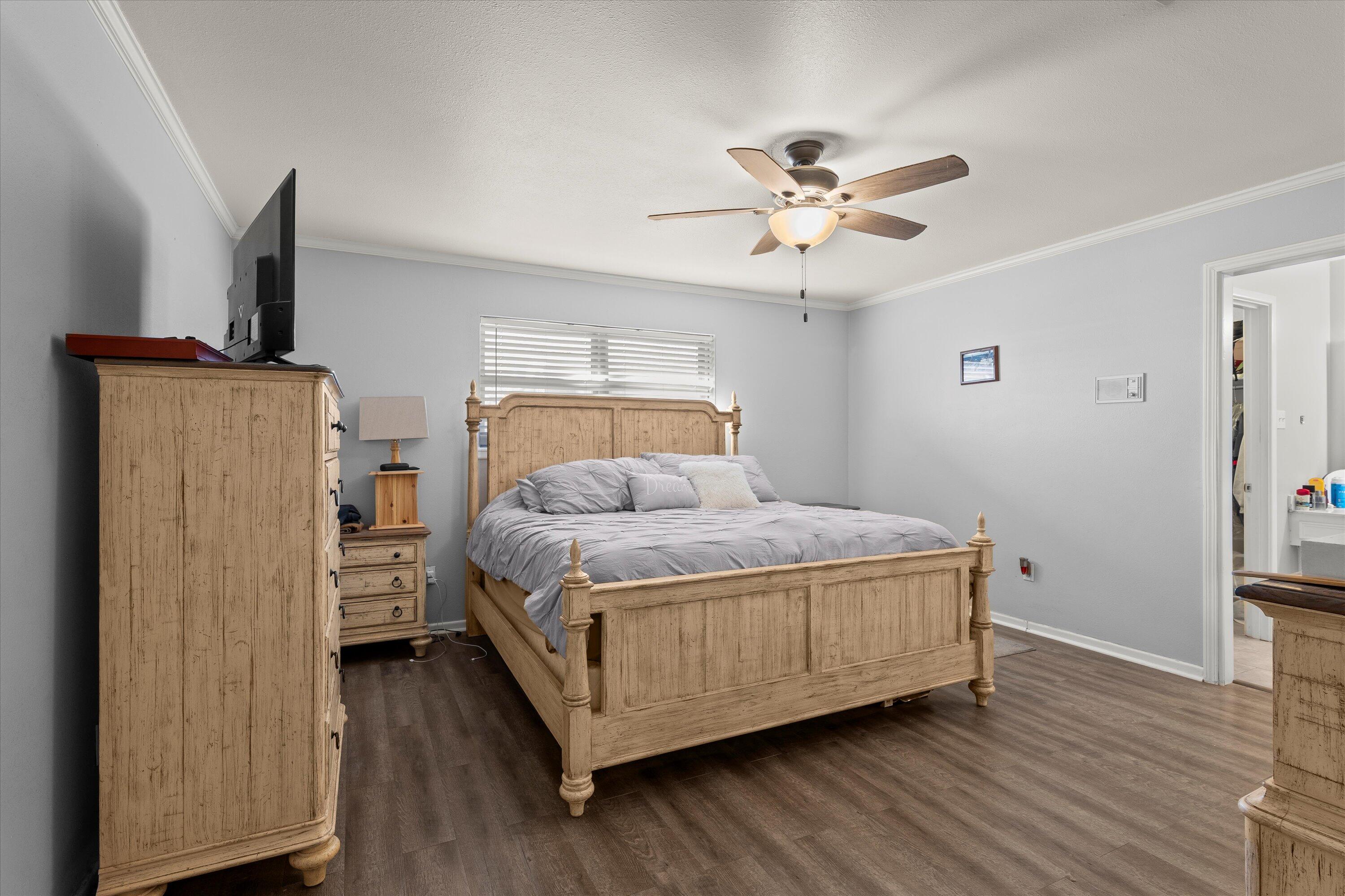 1007 South Howell Street Brownfield, TX 79316 - Photo 7 of 18 a bedroom with a bed and wooden floor