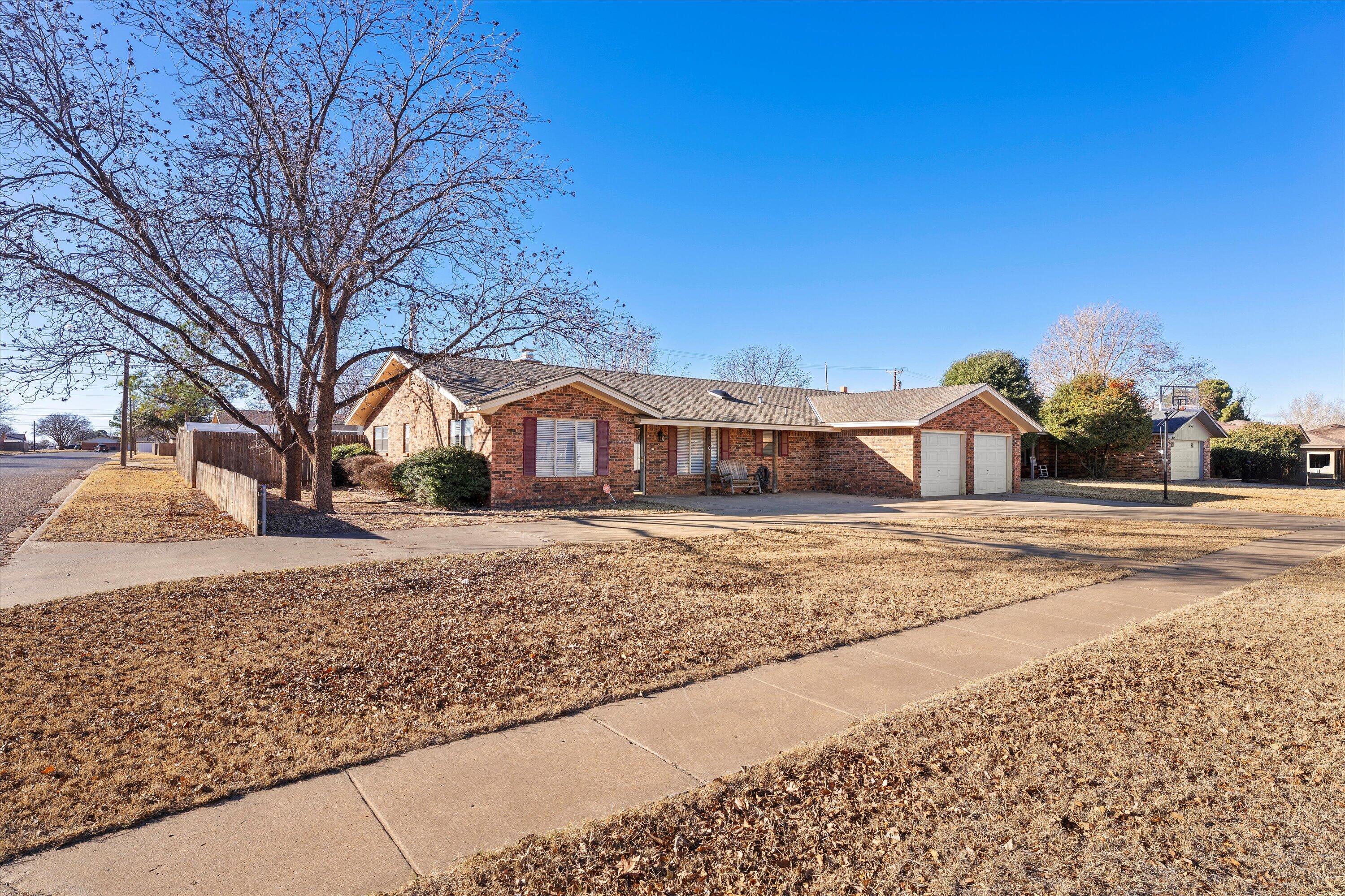 1007 South Howell Street Brownfield, TX 79316 - Photo 10 of 18 a front view of a house with a yard