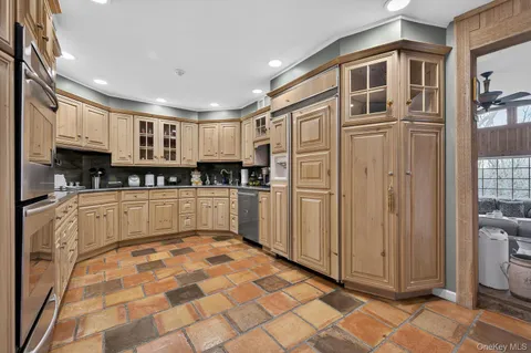 a open kitchen with stainless steel appliances granite countertop a refrigerator and cabinets