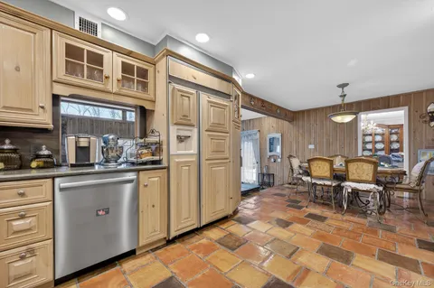 a kitchen with stainless steel appliances granite countertop a stove and cabinets