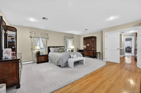 a spacious bedroom with a bed and couch