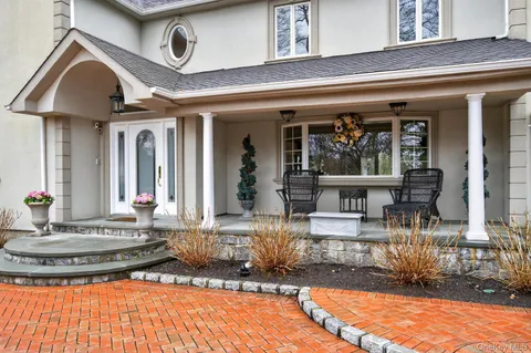 a living room with wooden floor and a stairs