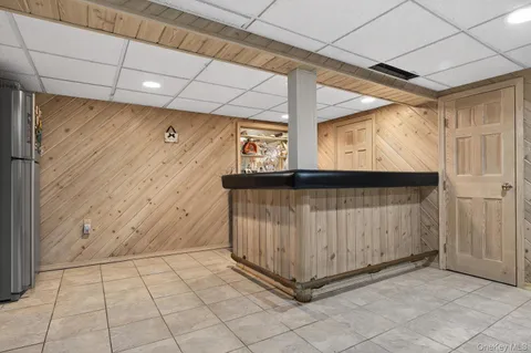 a view of a patio with a dining table and chairs with wooden fence
