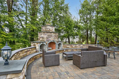 a view of a patio with a table and chairs under an umbrella