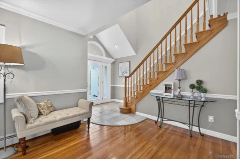 a view of entryway and hall with wooden floor