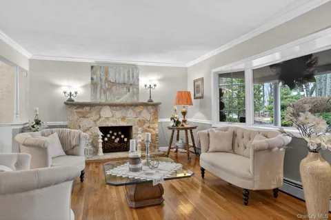 a living room with furniture large window and a fireplace