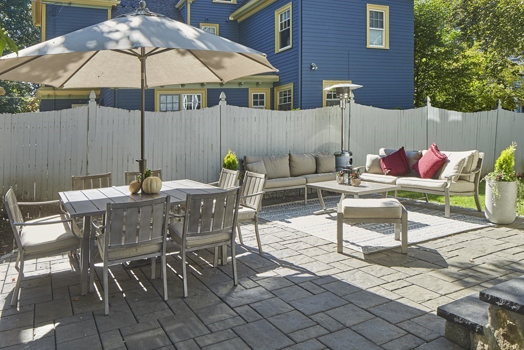 20 Orient Avenue Newton, MA 02459 - Photo 3 of 18 a view of a patio with a dining table and chairs under an umbrella