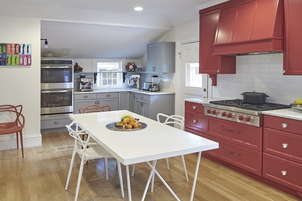 20 Orient Avenue Newton, MA 02459 - Photo 8 of 18 a kitchen with stainless steel appliances granite countertop a stove a sink dishwasher and cabinets with wooden floor
