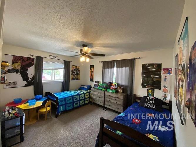 2113 Schaefer Drive Clarkston, WA 99403 - Photo 11 of 15 Carpeted bedroom with a textured ceiling and ceiling fan