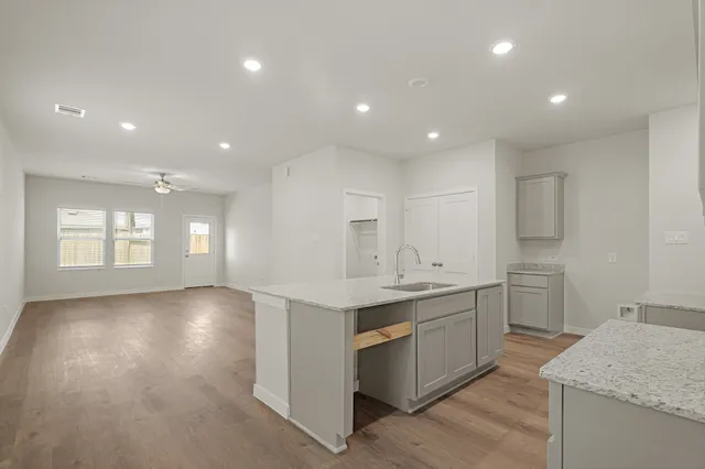 a kitchen with a sink stove and cabinets
