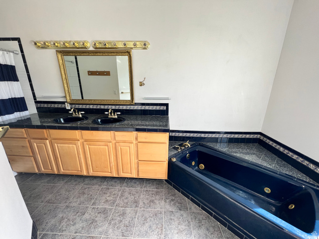 3013 North 100 West Provo, UT 84604 - Photo 14 of 18 Bathroom with a jetted tub, double vanity, curtained shower, and tile patterned flooring