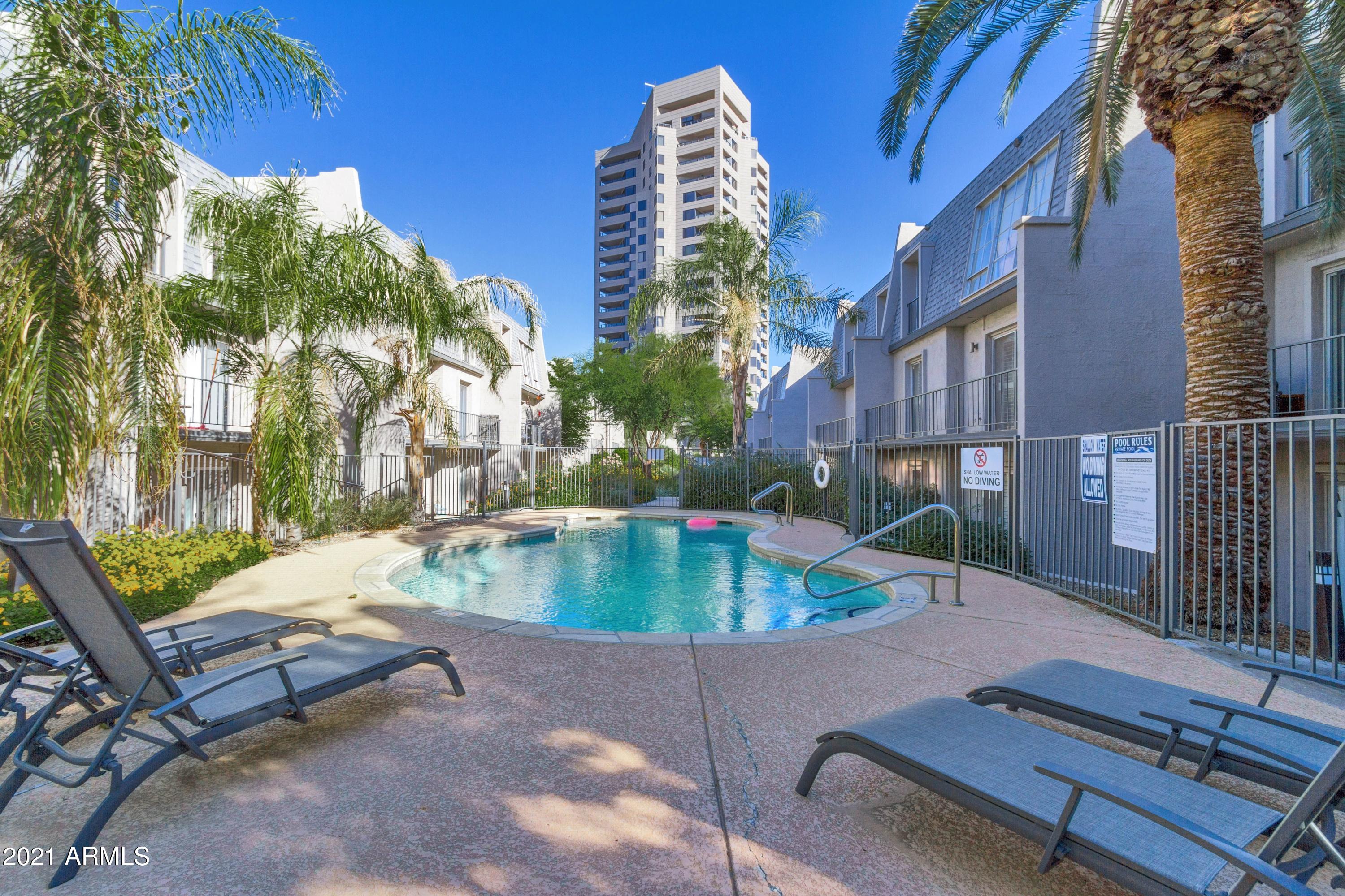 1002 East Osborn Road, Unit C Phoenix, AZ 85014 - Photo 13 of 15 a view of backyard with swimming pool and outdoor seating