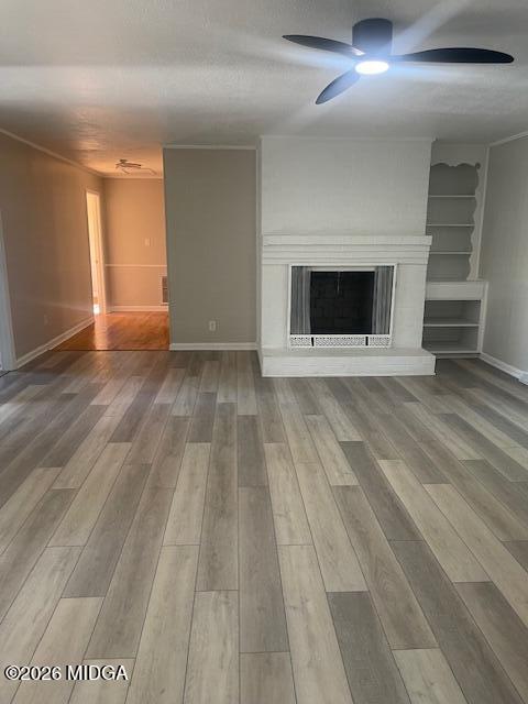 3688 Jessica Drive Macon, GA 31217 - Photo 3 of 14 en empty room with wooden floor and fireplace