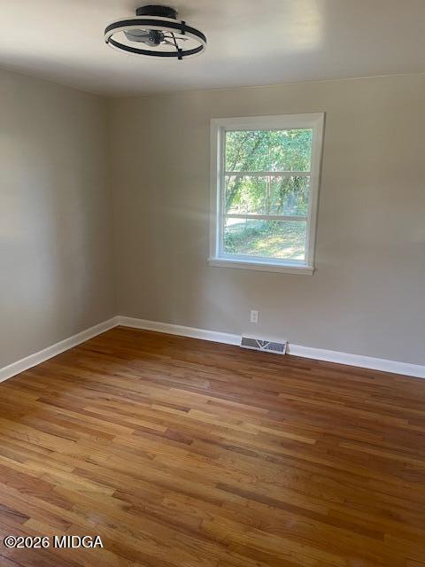 3688 Jessica Drive Macon, GA 31217 - Photo 7 of 14 an empty room with wooden floor and windows