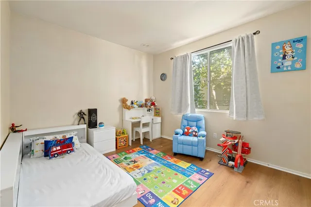 a play room with furniture and a wooden floor