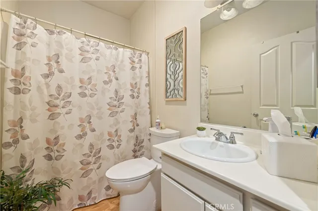 a bathroom with a sink toilet and a mirror