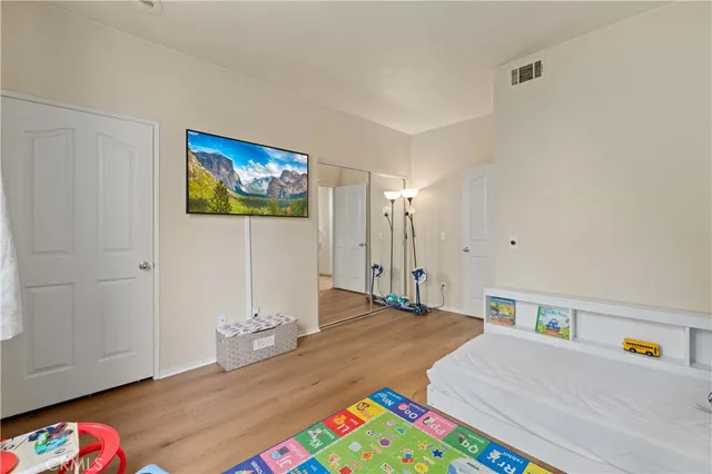 a bedroom with a bed and a bookshelf