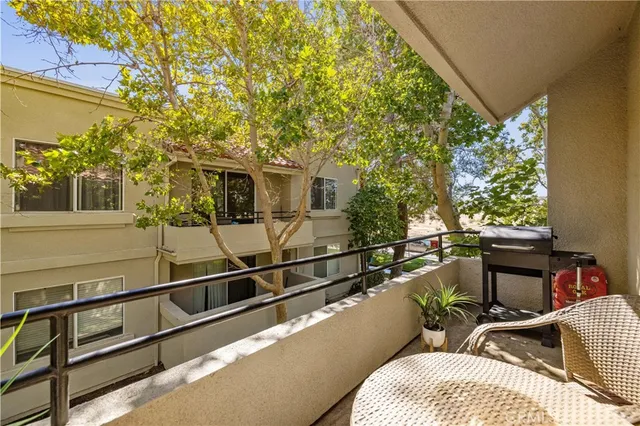 a balcony with table and chairs