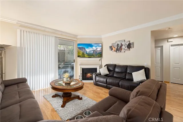a living room with furniture a fireplace and a large window