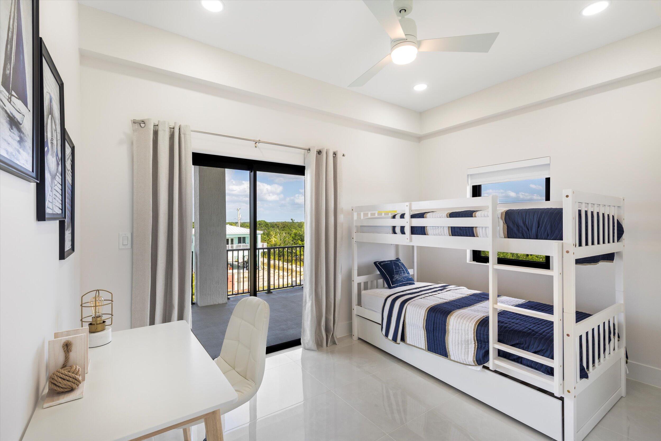 27433 Antigua Road Summerland Key, FL 33042 - Photo 53 of 64 a bedroom with furniture and a window