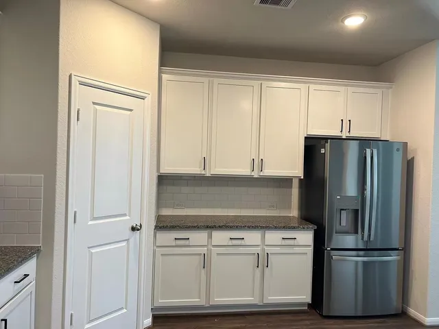 a kitchen with cabinets and stainless steel appliances