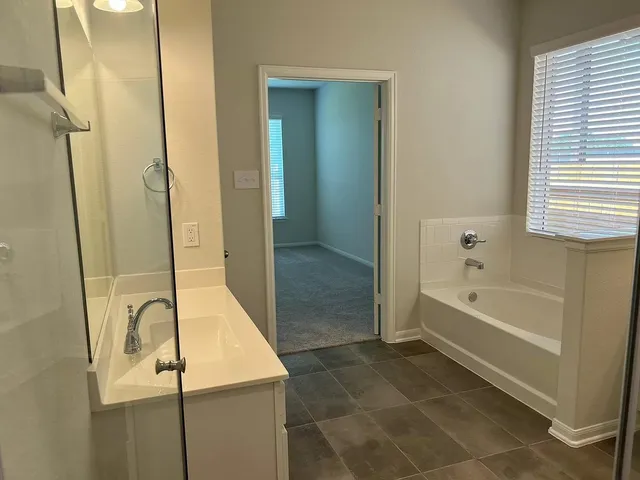 a bathroom with a bathtub and a shower
