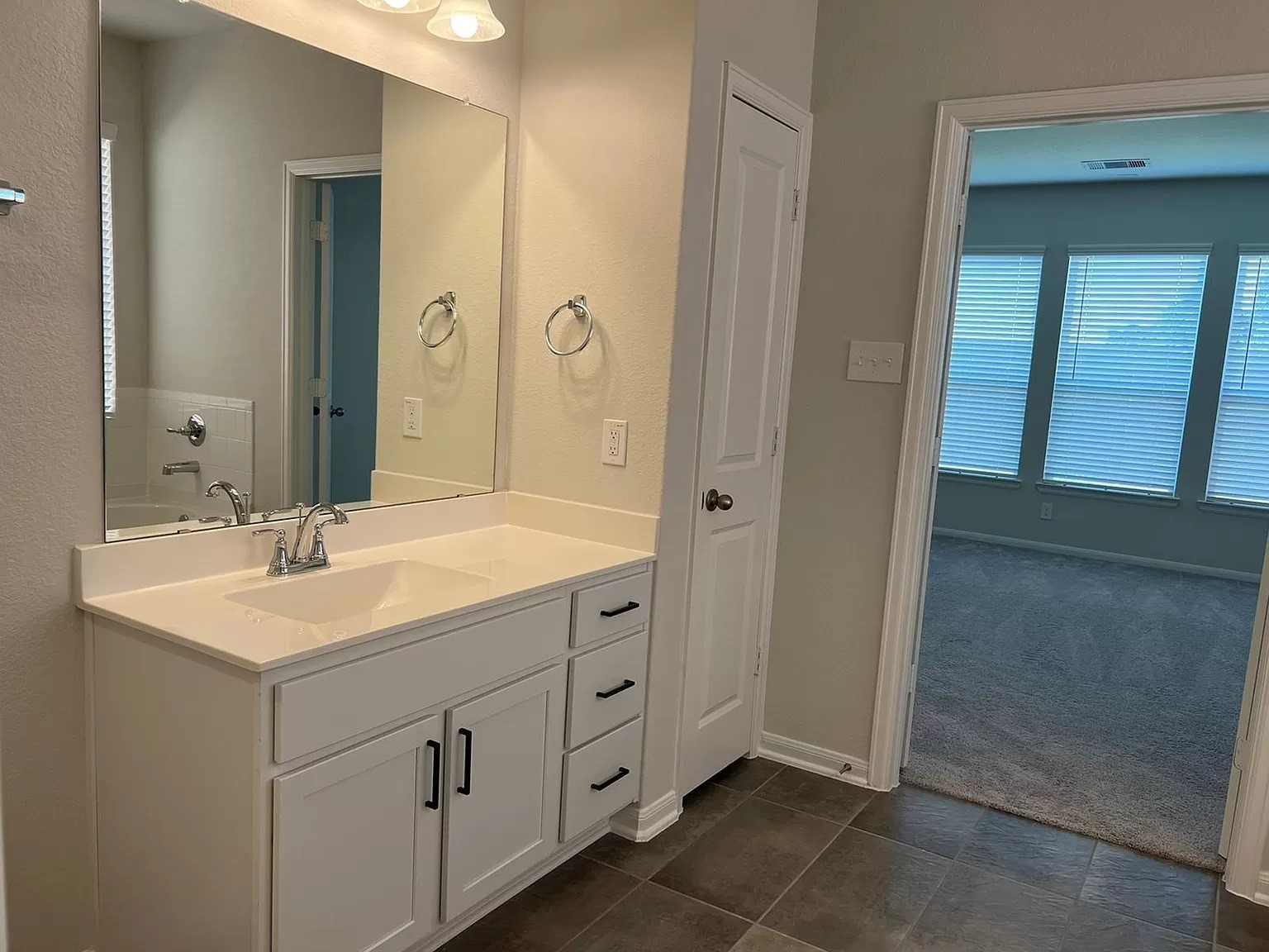 21219 Bering Reach Drive Cypress, TX 77433 - Photo 21 of 26 a bathroom with a double vanity sink and a mirror