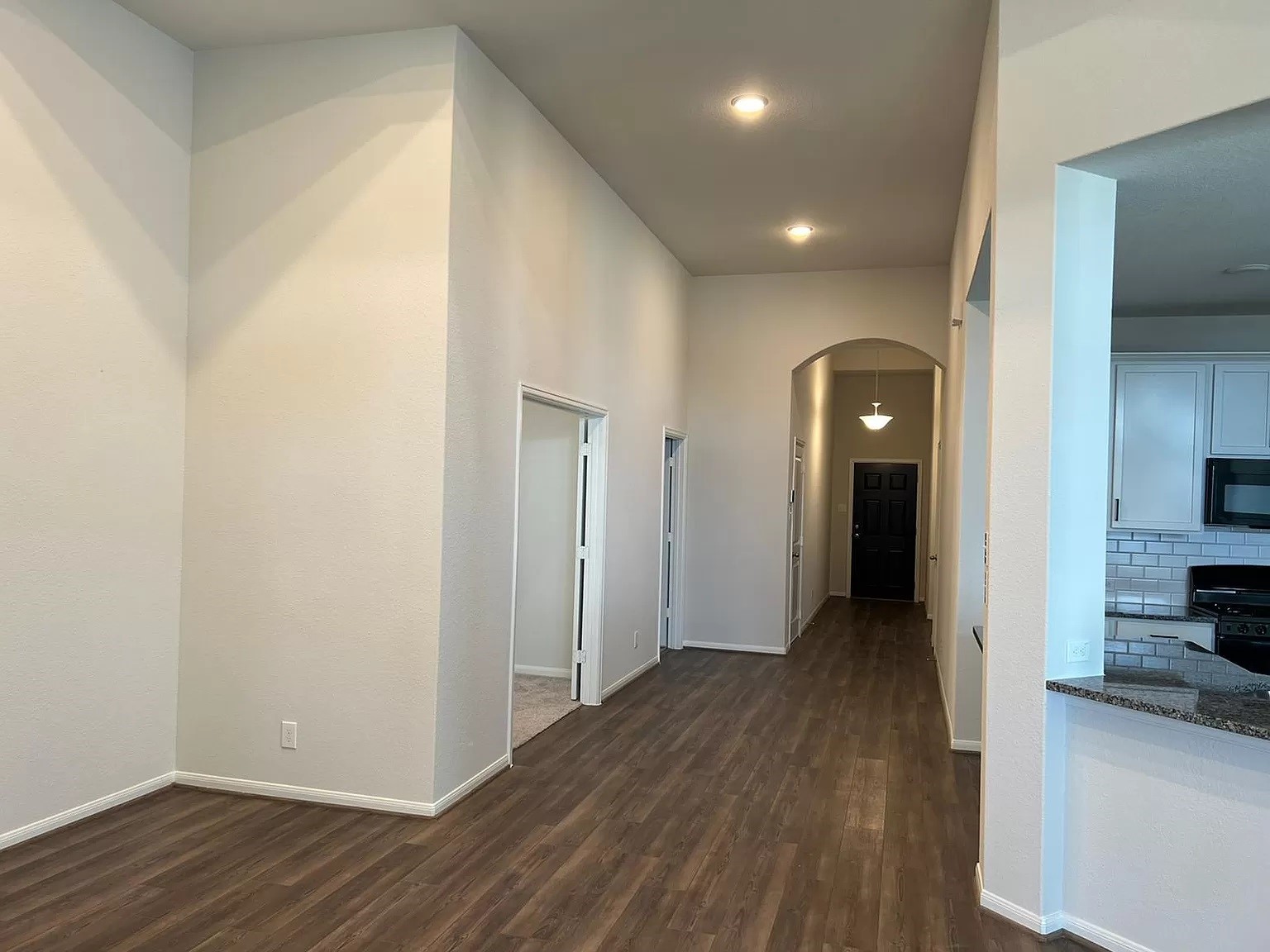 21219 Bering Reach Drive Cypress, TX 77433 - Photo 4 of 26 a view of a hallway with wooden floor and a living room