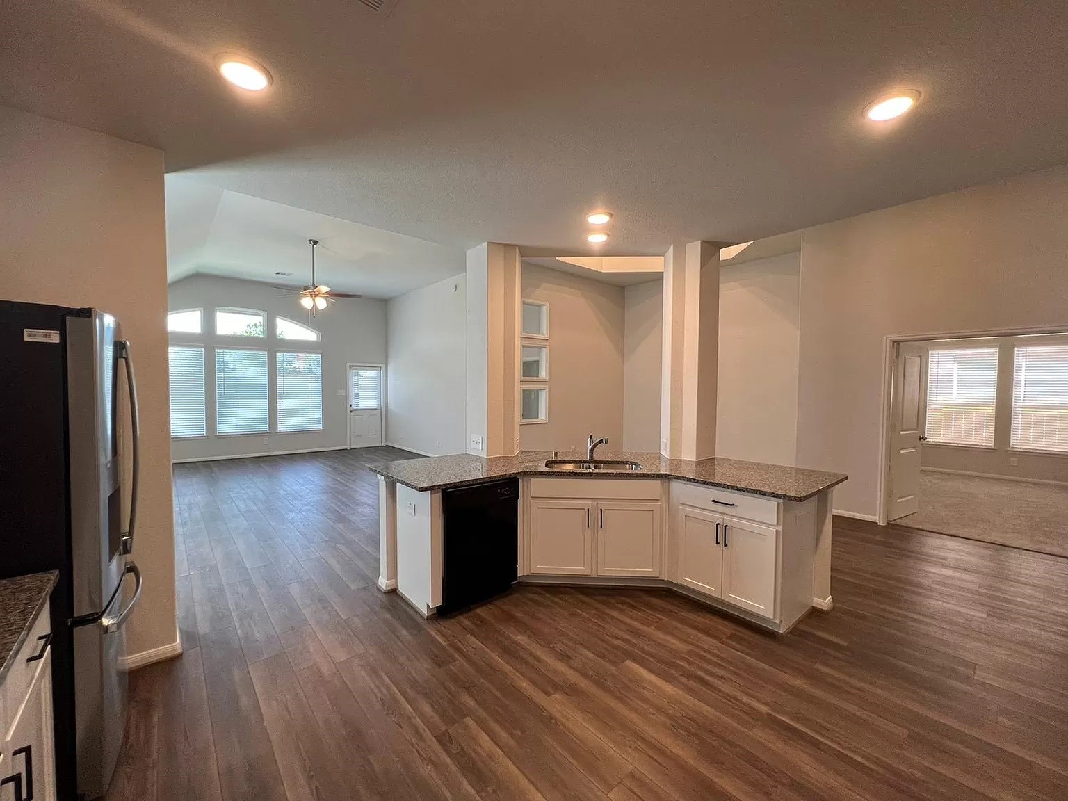 21219 Bering Reach Drive Cypress, TX 77433 - Photo 10 of 26 a large kitchen with stainless steel appliances granite countertop a large stove a sink dishwasher and a refrigerator with wooden floor