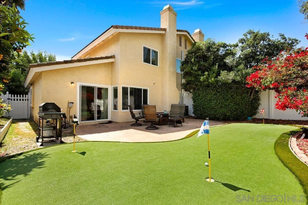 a view of a backyard with plants and a patio