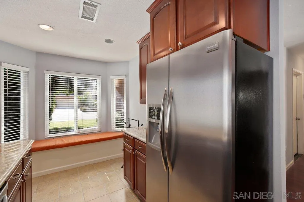 13547 Ridley Road San Diego, CA 92129 - Photo 12 of 24 a kitchen with stainless steel appliances granite countertop a refrigerator and a sink
