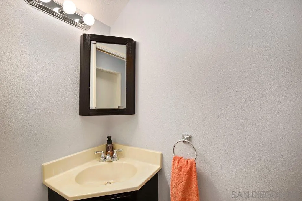 13547 Ridley Road San Diego, CA 92129 - Photo 14 of 24 a bathroom with a sink and a mirror
