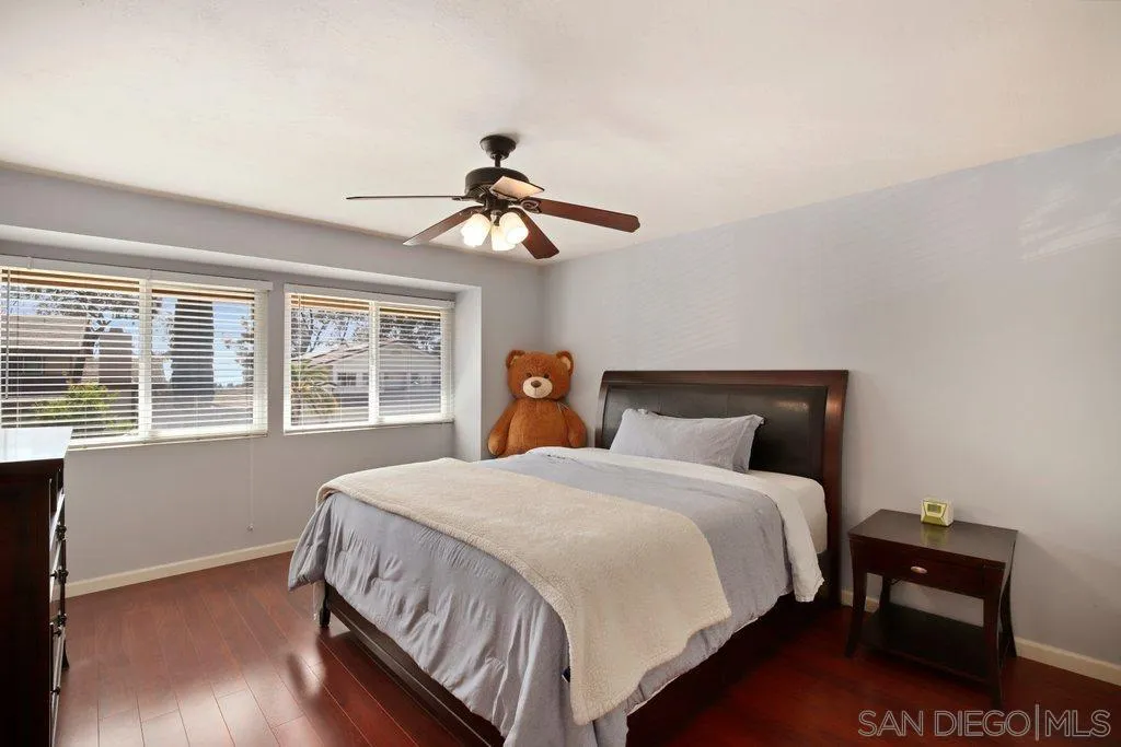 13547 Ridley Road San Diego, CA 92129 - Photo 15 of 24 a bedroom with a bed and wooden floor