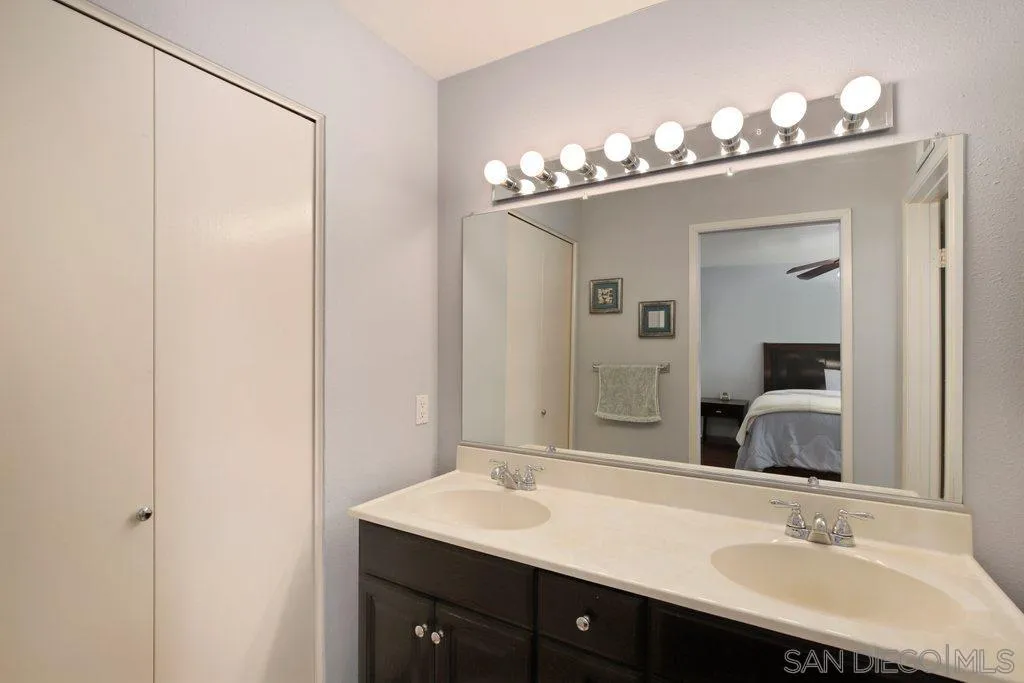 13547 Ridley Road San Diego, CA 92129 - Photo 17 of 24 a bathroom with a sink vanity and a mirror