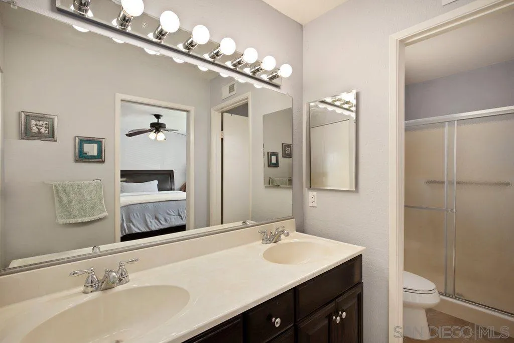 13547 Ridley Road San Diego, CA 92129 - Photo 18 of 24 a bathroom with a sink and a mirror