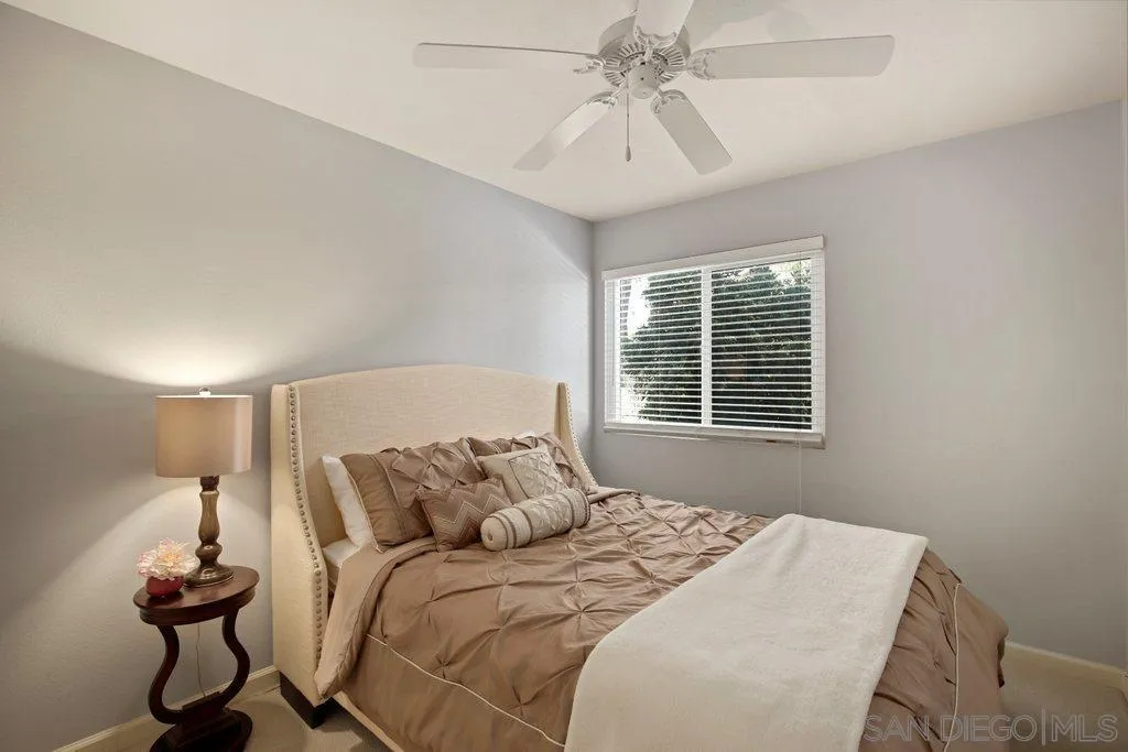 13547 Ridley Road San Diego, CA 92129 - Photo 19 of 24 a bedroom with a bed and a window