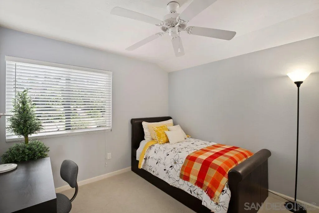 13547 Ridley Road San Diego, CA 92129 - Photo 20 of 24 a bedroom with a bed and a chandelier