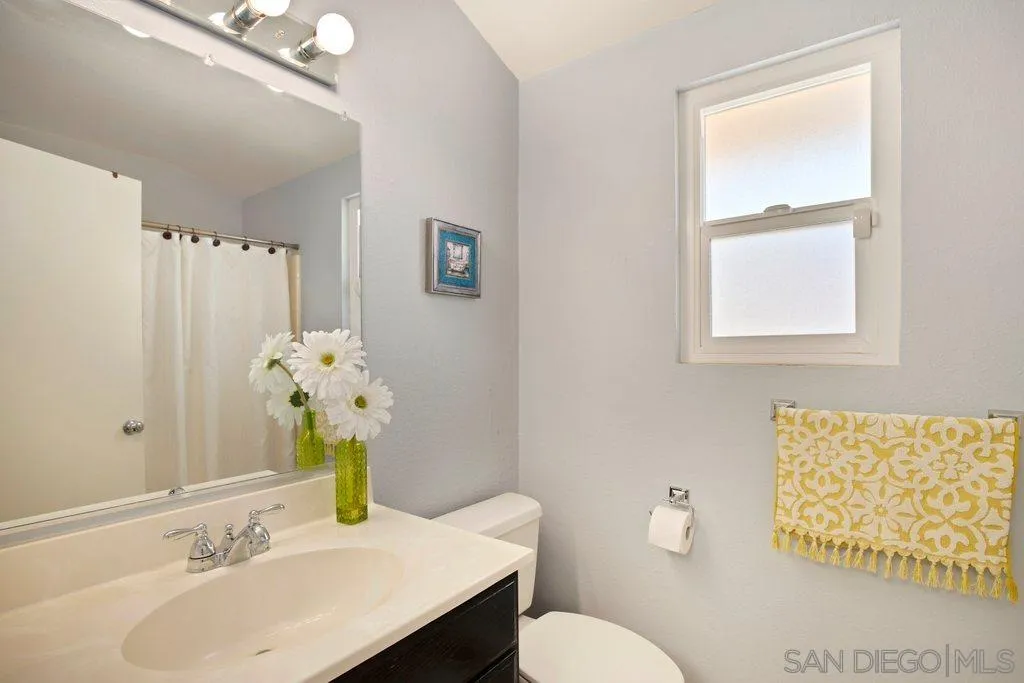 13547 Ridley Road San Diego, CA 92129 - Photo 21 of 24 a bathroom with a sink mirror and toilet