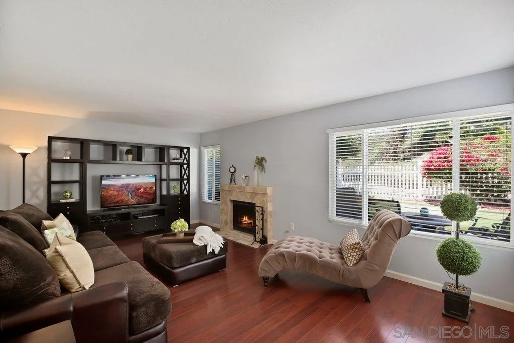 13547 Ridley Road San Diego, CA 92129 - Photo 3 of 24 a living room with furniture a fireplace and a flat screen tv