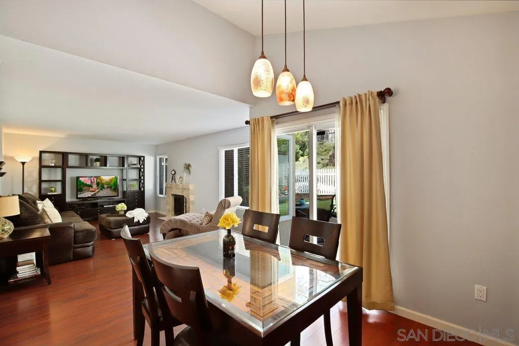 13547 Ridley Road San Diego, CA 92129 - Photo 6 of 24 a view of a dining room with furniture wooden floor and chandelier