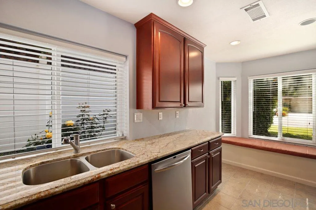 13547 Ridley Road San Diego, CA 92129 - Photo 10 of 24 a kitchen with granite countertop a sink and a window