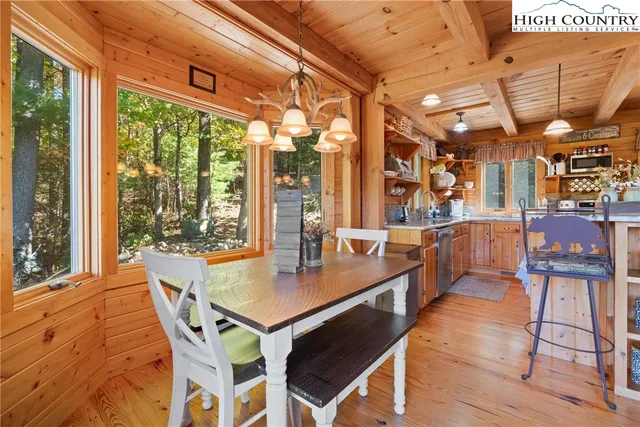 a dining room with stainless steel appliances granite countertop a stove a kitchen island a table and chairs