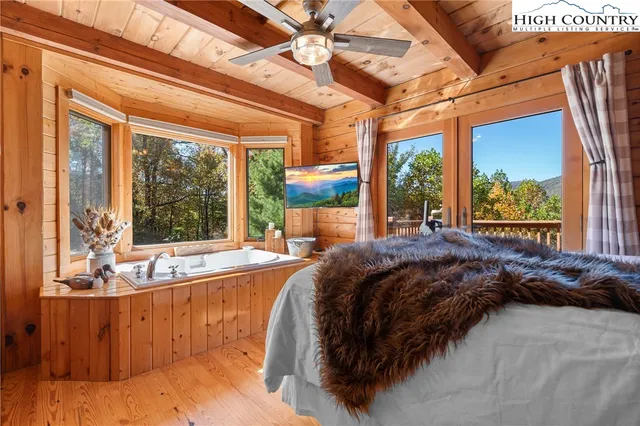 a bed sitting in a bedroom next to a large window