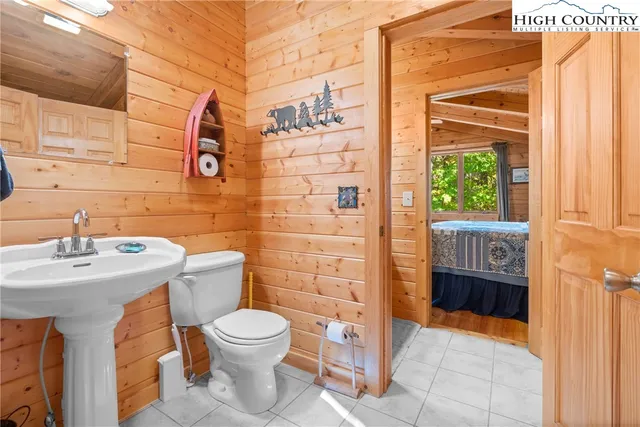 a bathroom with a toilet a sink and shower