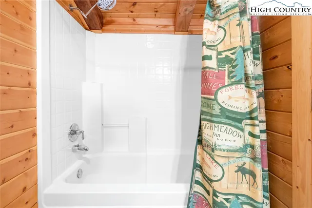 a bathroom with a bathtub and shower