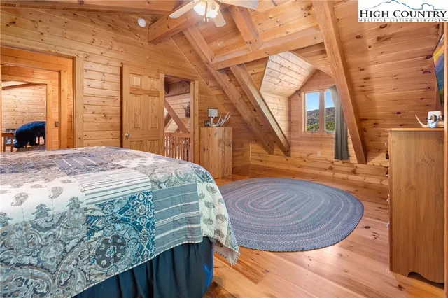 a bed sitting in a bedroom next to a window