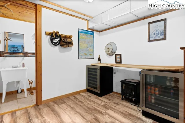 a view of a hallway with workspace and a window